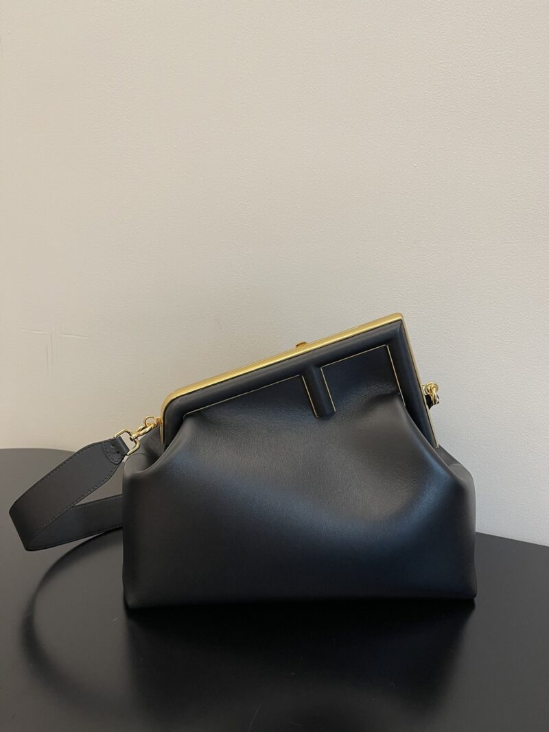 Replica Fendi First Small Black Nappa Leather Bag with metallic F-shaped clasp and detachable shoulder strap.