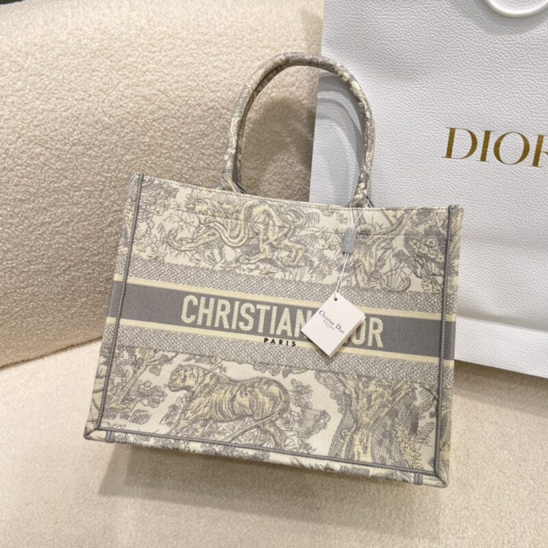 Replica Dior Medium Book Tote Ecru and Gray Toile de Jouy Embroidery in premium canvas with signature Dior logo and intricate embroidery for a timeless, elegant look.